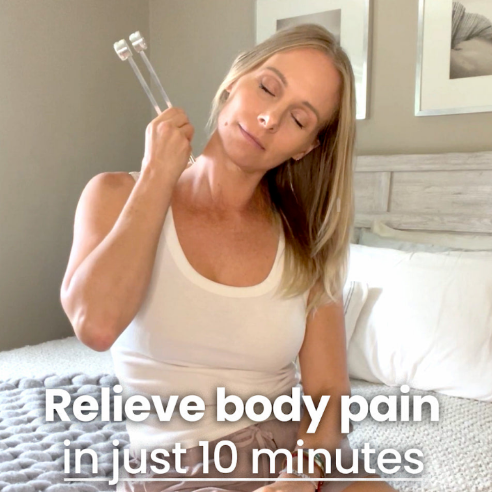 Woman applying tuning fork to neck